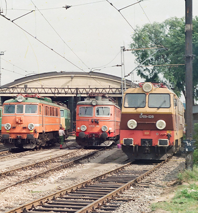 Zdjęcie kolorowe. Na stacji kolejowej stoją lokomotywy pociągów. Pociągi ekspresowe kategorii Intercity. Pociągi kursujące w latach 90. XX wieku