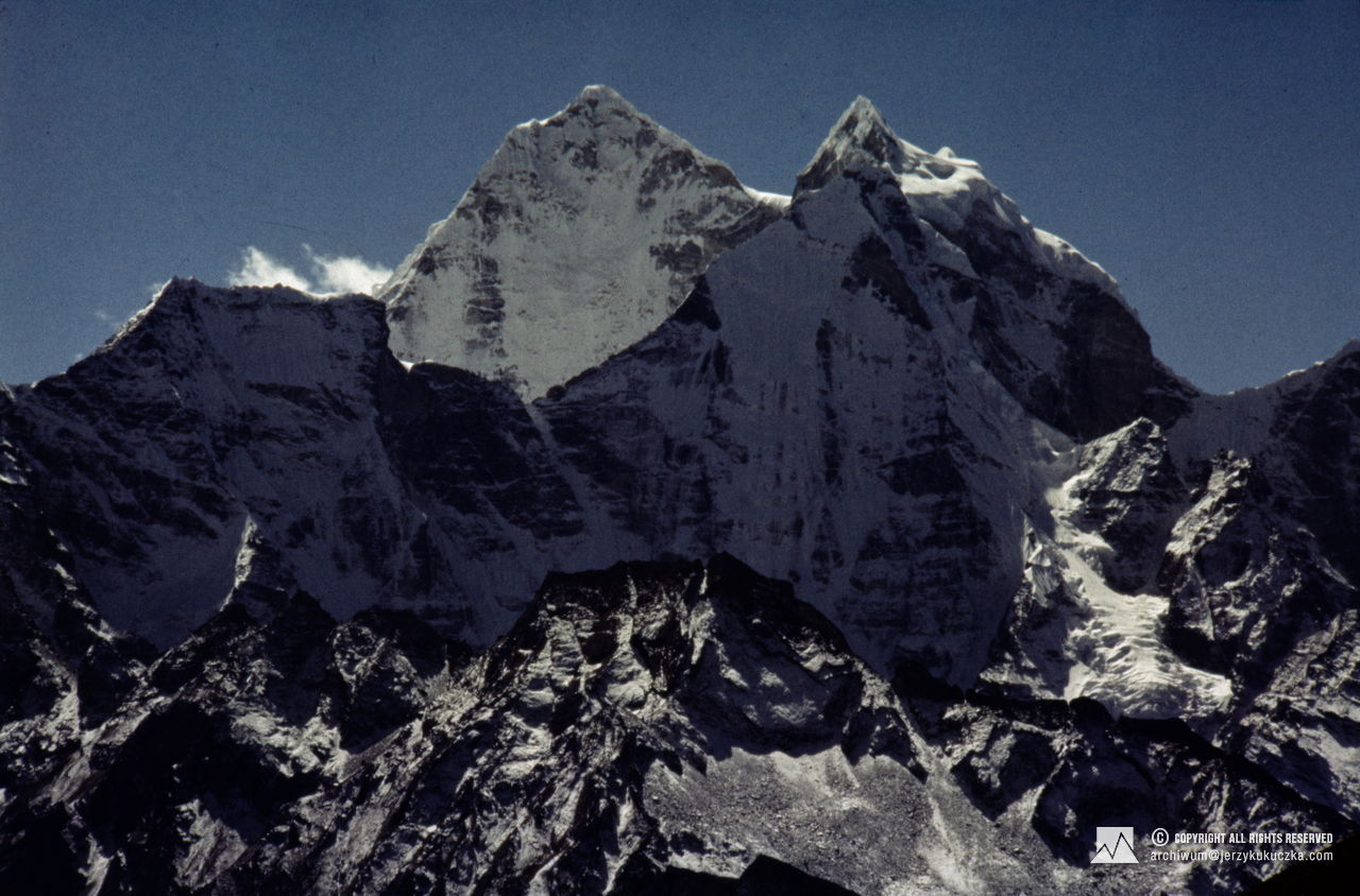 Pokryte śniegiem szczyty Nuptse i Lhotse majestatycznie wznoszą się na tle czystego, błękitnego nieba w Himalajach.